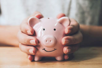 Photo of someone holding a piggy bank